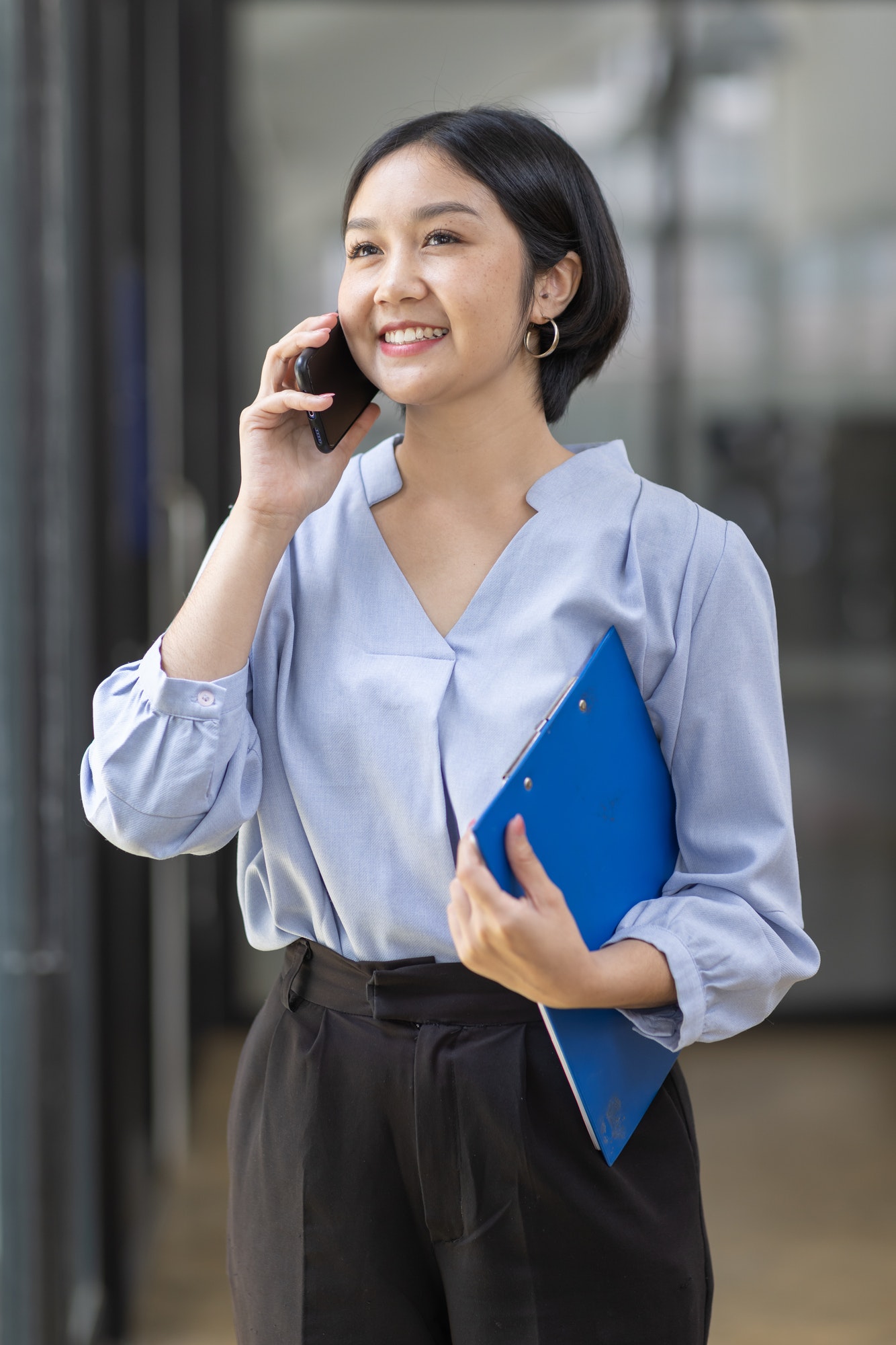 Asian woman talking on a mobile phone at workplace office, Asian student girl or Business woman.
