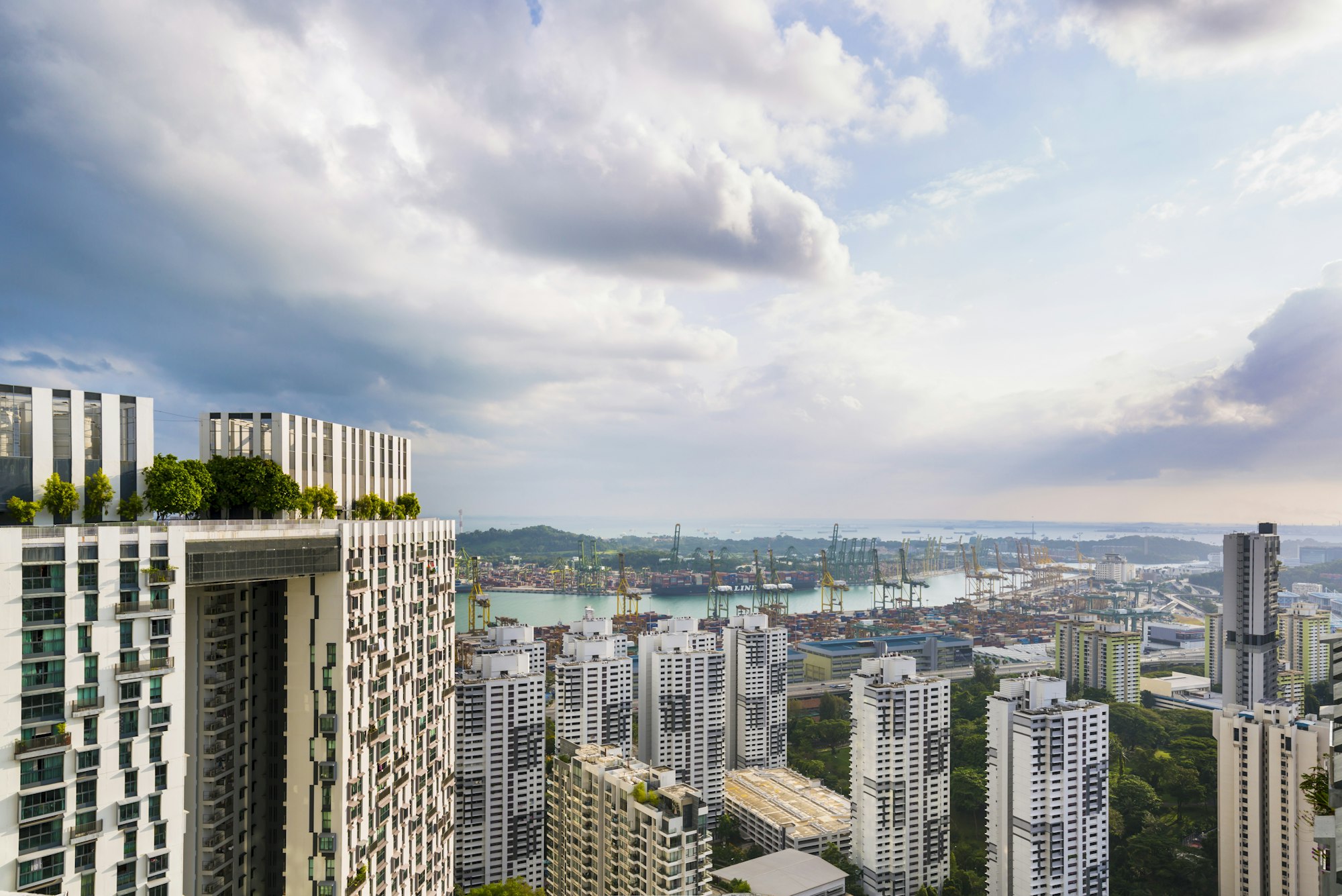 Elevated cityscape with apartment exteriors and coast, Singapore, South East Asia